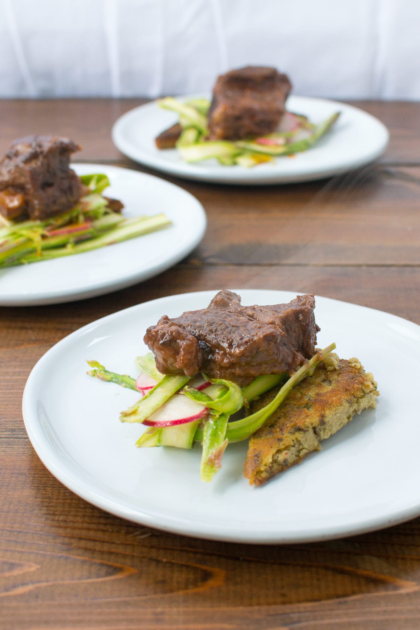 short ribs over fried polenta and shaved asparagus salad - Appetites Anonymous